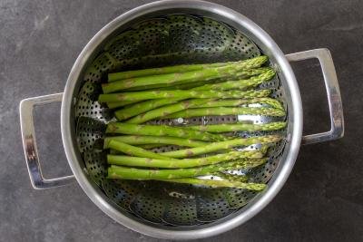 Asparagus steaming in a pot