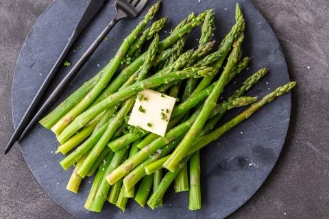 Steamed Asparagus on a serving tray with butter