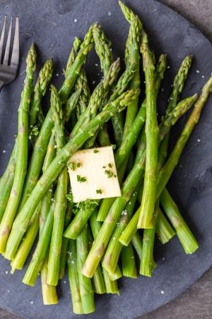 Steamed Asparagus on a serving tray with butter