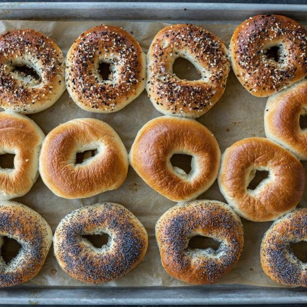 Baked bagels on a baking sheet.