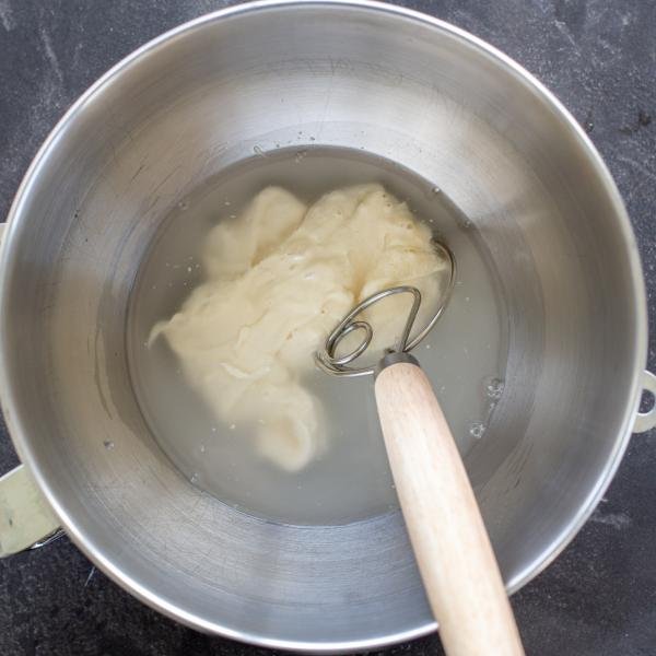 Sourdough starter with water in a bowl.