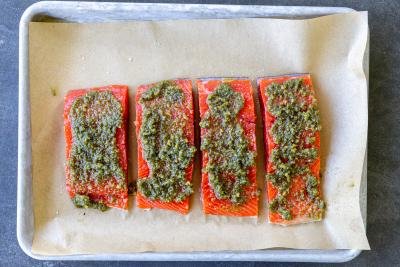 Salmon with pesto on top of salmon.