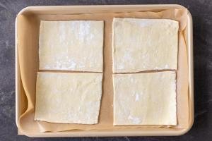 Sliced puff pastry on a baking sheet