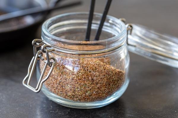 Taco seasoning in a jar with a spoon