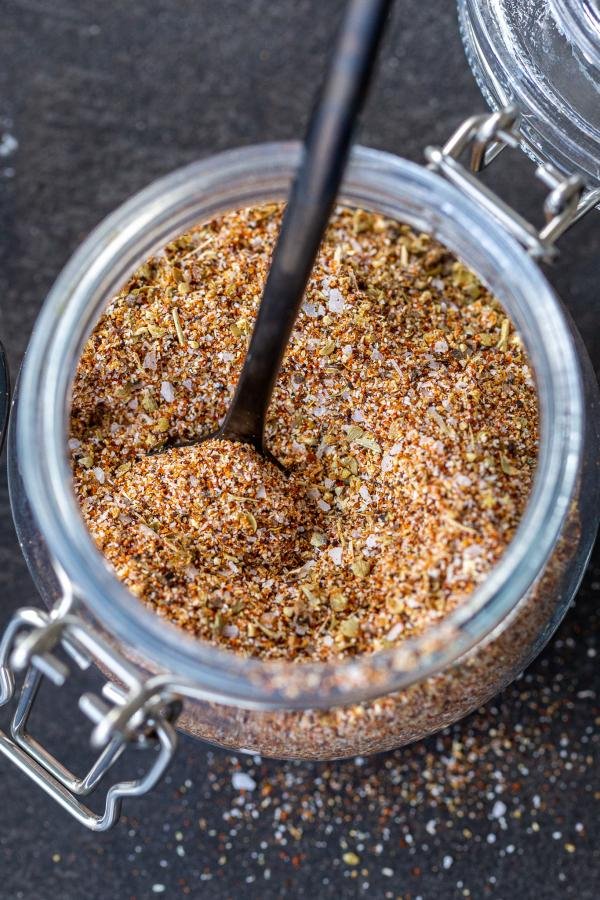 Taco seasoning in a jar with a spoon