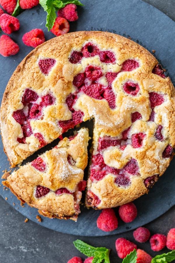 The Easiest Raspberry Coffee Cake on a tray with berries. 