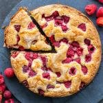 The Easiest Raspberry Coffee Cake on a tray with berries.