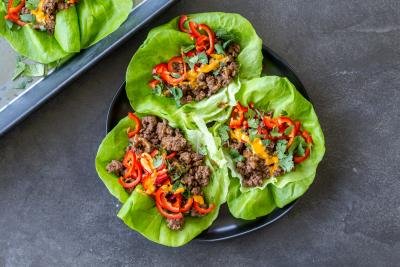 Three Beef lettuce wraps on a plate.