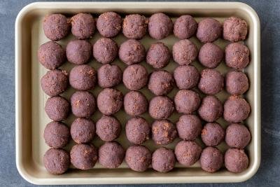 Chocolate cake balls on a baking sheet.