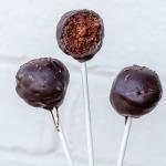 Three Chocolate Cake Pops in a hand.