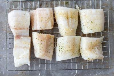 Cod on a grilling rack.