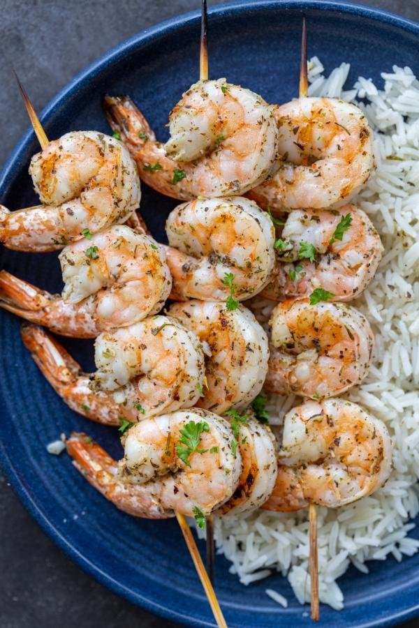 Grilled shrimp on a plate with rice. 