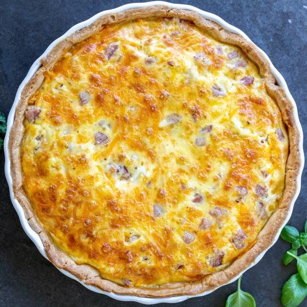 A slice Ham and Cheese Quiche in a serving tray.