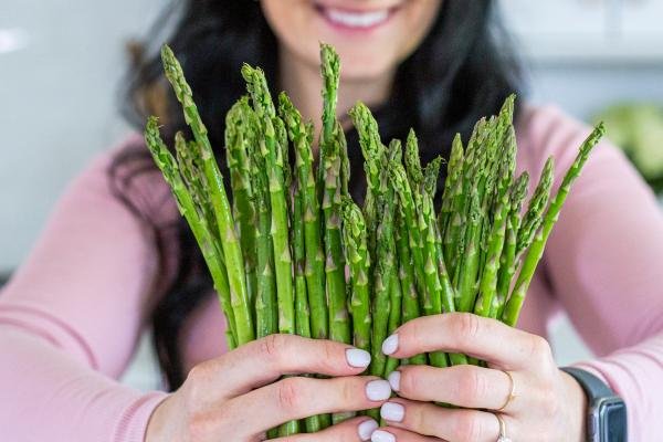 Asparagus held in hand.