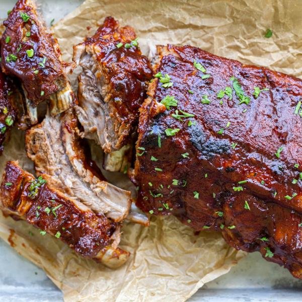 Sliced ribs on a baking pan and parchment paper.