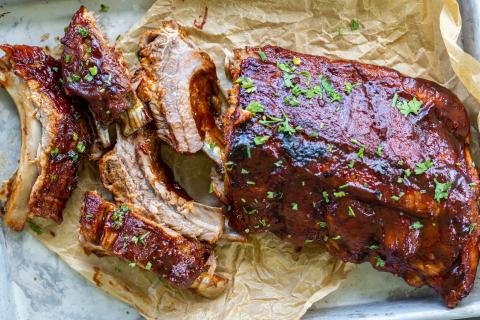 Sliced ribs on a baking pan and parchment paper.