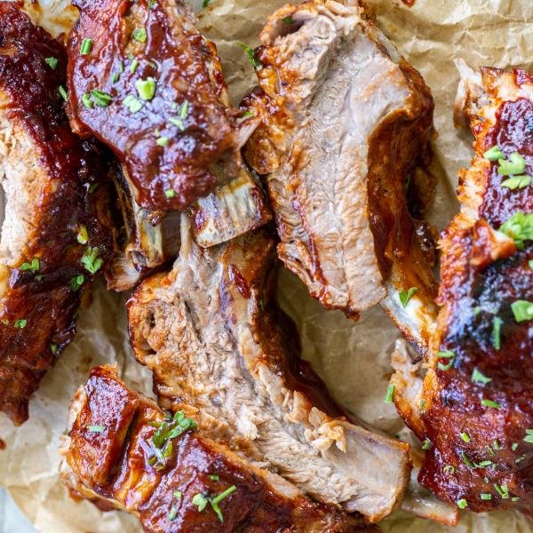 BBQ ribs on a baking pan with herbs.