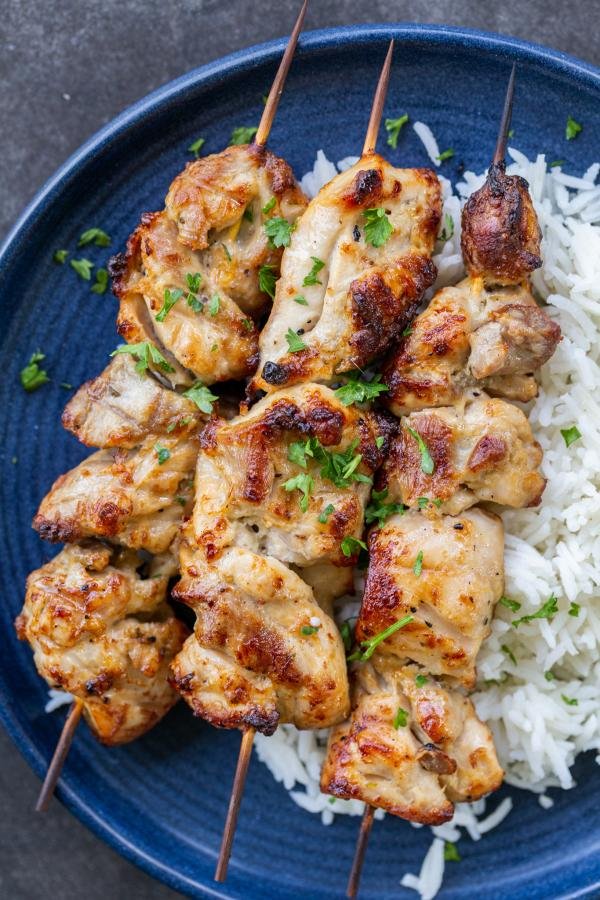 Oven-Baked Chicken Kabobs on a plate with rice. 