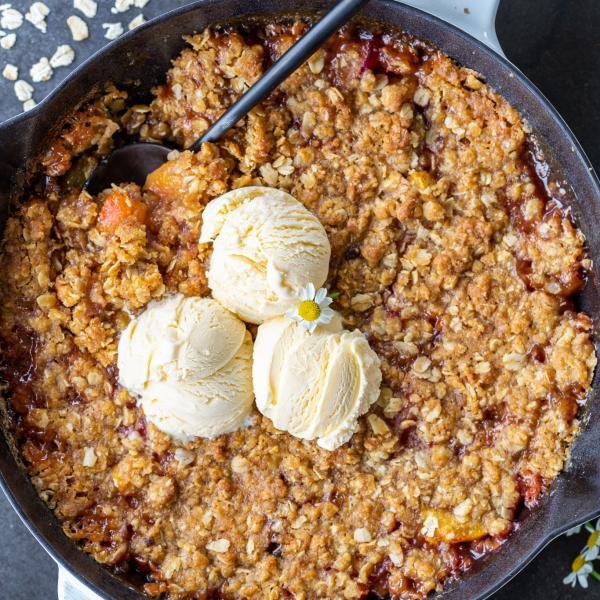 Peach Crisp with ice cream a pan.