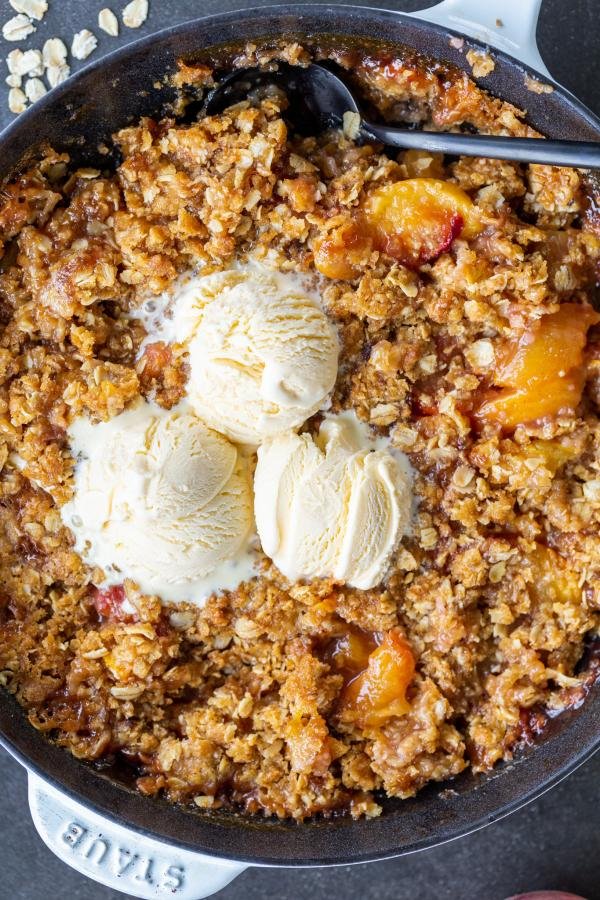 Peach Crisp with ice cream a pan.