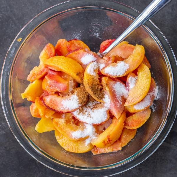 Peaches with sugar and cinnamon in a bowl