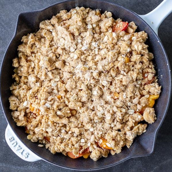 Non baked peach crisp in a pan.