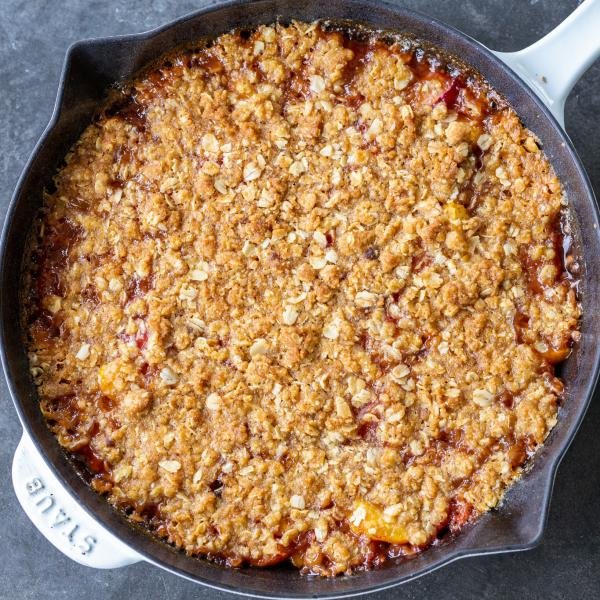 Baked peach crisp in a pan.