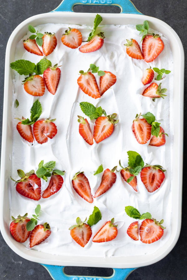 Strawberry Jello Poke Cake in a serving tray. 