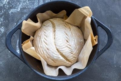Bread with parchment paper in a pot.