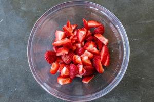 Sliced strawberries in a bowl.