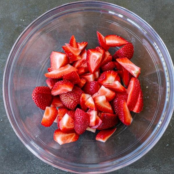 Sliced strawberries in a bowl.