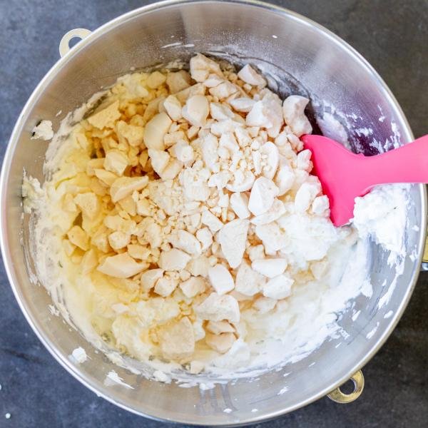Meringue in a mixing bowl with heavy cream.