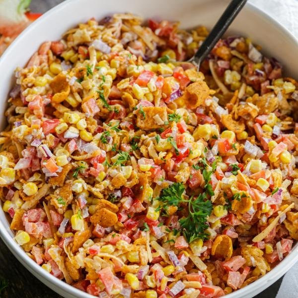 Fritos chili cheese salad in a large bowl