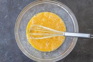 Eggs in a bowl with seasoning.