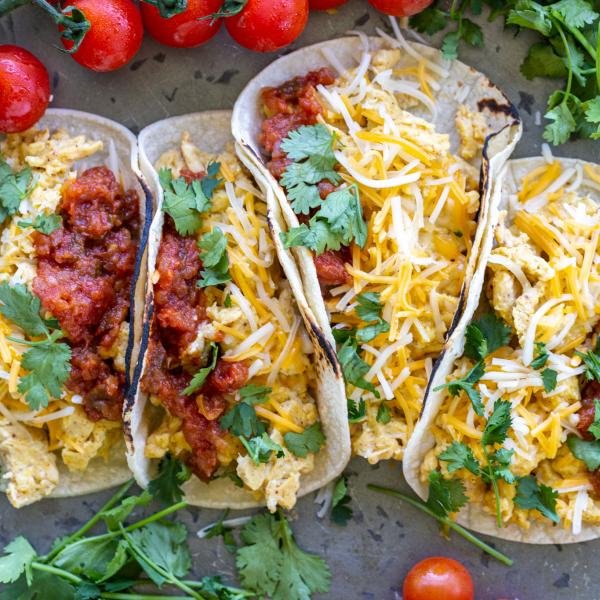 Good Egg Tacos on a tray with herbs.