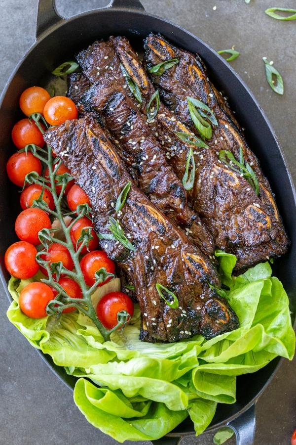 Grilled Beef Galbi on a serving tray with veggies.