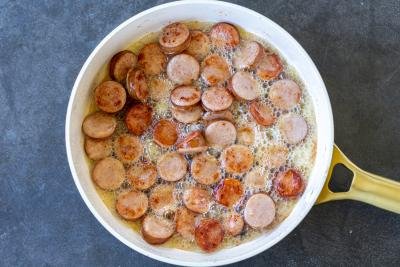 Sausage and butter in a pan.