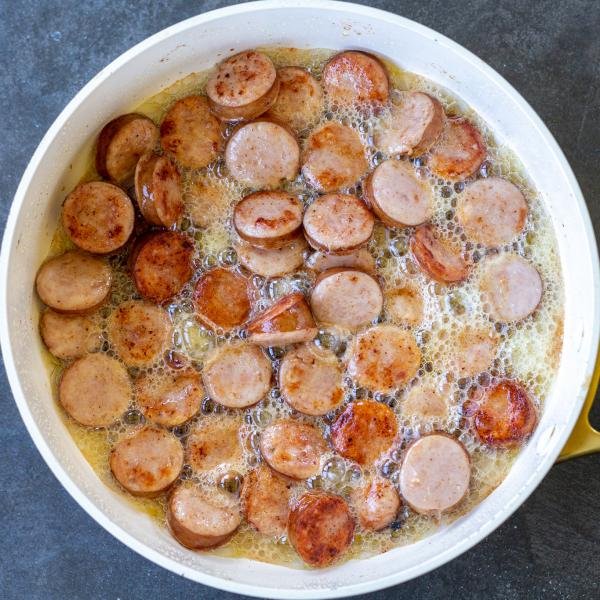 Sausage and butter in a pan.