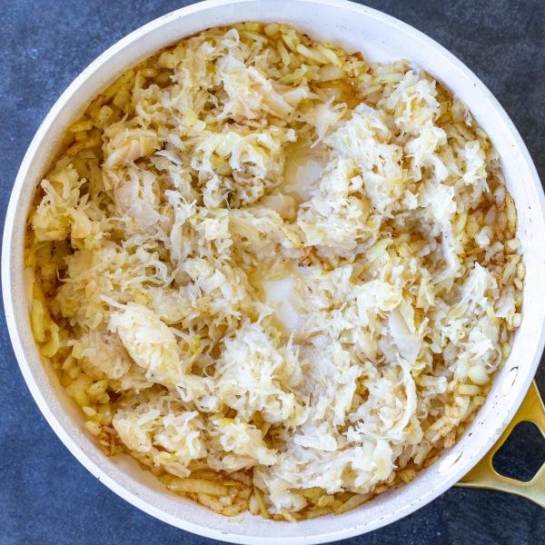 Sauerkraut in a pan with onion and butter.