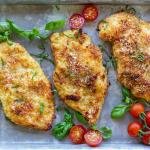 Parmesan Crusted Chicken with herbs on a tray.