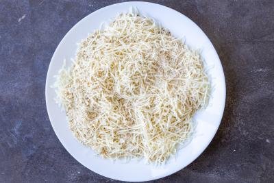 Parmesan cheese and bread crumbs on a plate.