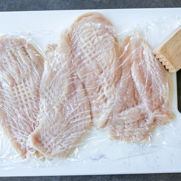 Tenderized chicken on a baling sheet.