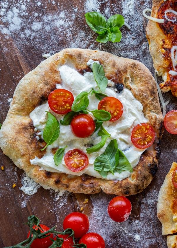 Prepared pizza with toppings on a tray.