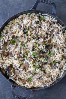 Mushroom Risotto in a pan with herbs.