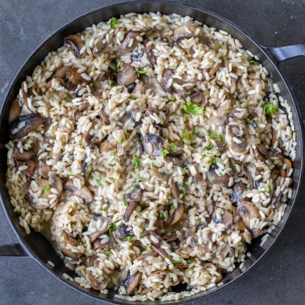 Mushroom Risotto in a pan with herbs.