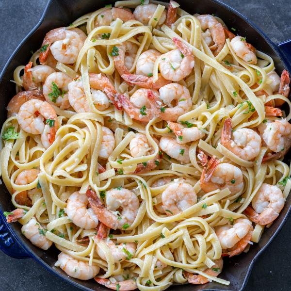 Shrimp Linguine in a pan with herbs and Parmesan.