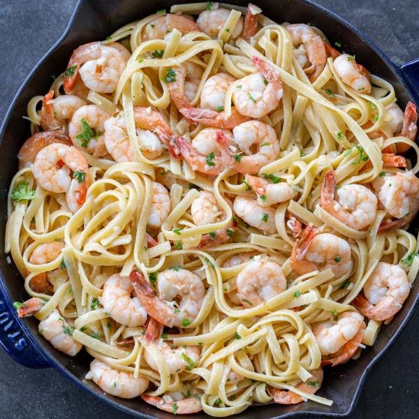 Shrimp Linguine in a pan with herbs and Parmesan.