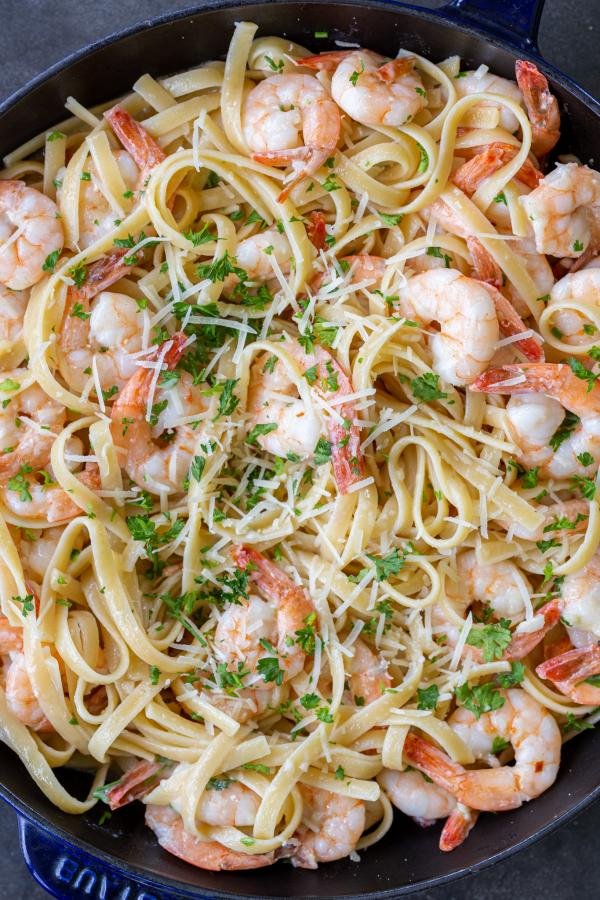 Shrimp Linguine in a pan with herbs and Parmesan.