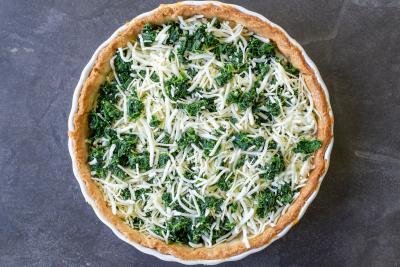 Quiche crust with spinach and cheese.