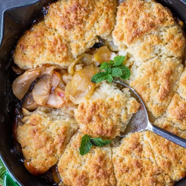 Apple cobbler with a serving spoon.